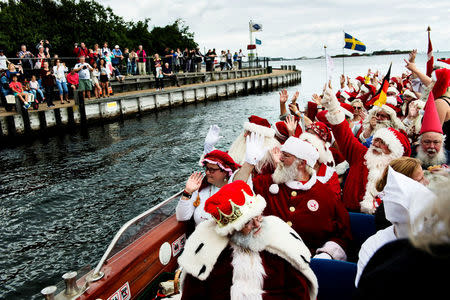 Participants from different countries, and seen on a boat cruise, take part in the 59th World Santa Convention in Copenhagen July 18, 2016. Scanpix Denmark/Mathias Loevgreen Bojesen/via REUTERS