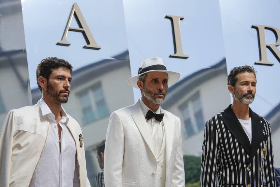 Models wear creations as part of the Billionaire men's Spring Summer 2023 collection presented in Milan, Italy, Friday, June 17, 2022. (AP Photo/Luca Bruno)