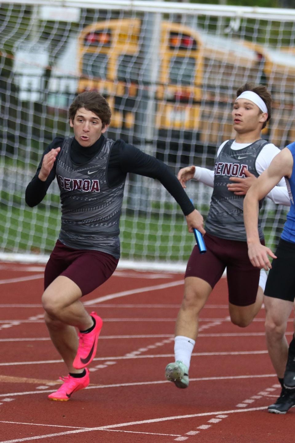 Genoa's Griffin Meyer takes the baton from RJ Adkins in the 4x100 relay.