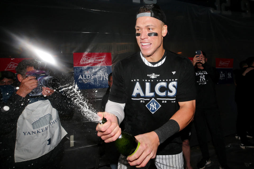 Oct 18, 2022; Bronx, New York, USA; New York Yankees right fielder Aaron Judge (99) celebrates in the clubhouse after their win against the Cleveland Guardians in game five of the ALDS for the 2022 MLB Playoffs at Yankee Stadium. Mandatory Credit: Brad Penner-USA TODAY Sports