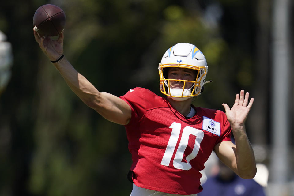 Los Angeles Chargers quarterback Justin Herbert (10) participates in drills during a combined NFL practice with the Dallas Cowboys at the Los Angeles Rams' practice facility in Costa Mesa, Calif. Thursday, Aug. 18, 2022. (AP Photo/Ashley Landis)