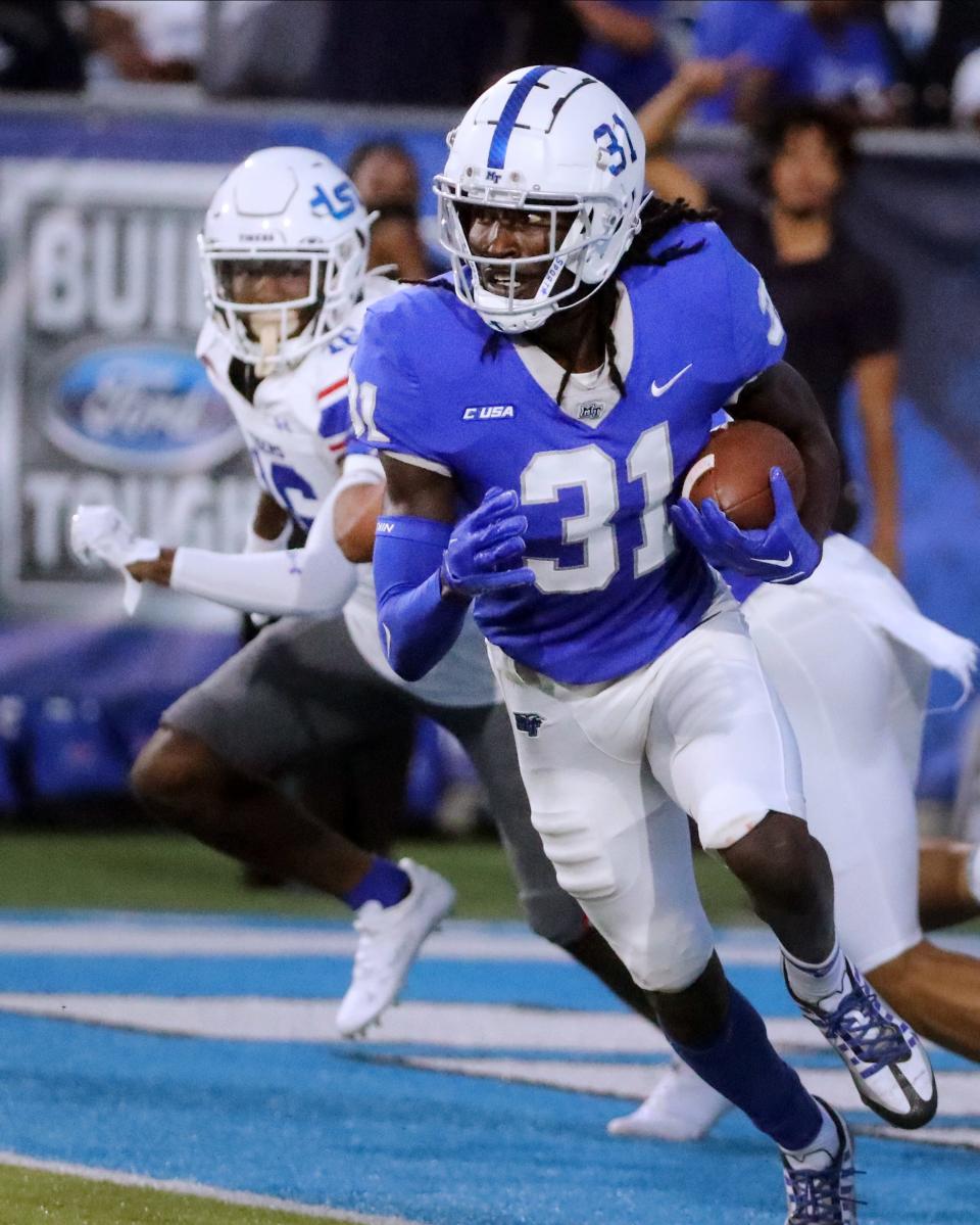 MTSU cornerback Deonte Stanley (31) runs the ball after he intercepts a pass intended for TSU wide receiver John Roberts IV (16) on Saturday, Sept. 17, 2022, during MTSU's home opener. 