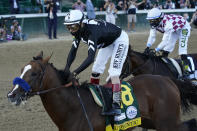 Jockey John Velazquez riding Authentic (18) crosses the finish line ahead of Jockey Manny Franco riding Tiz the Law to win the 146th running of the Kentucky Derby at Churchill Downs, Saturday, Sept. 5, 2020, in Louisville, Ky. (AP Photo/Jeff Roberson)