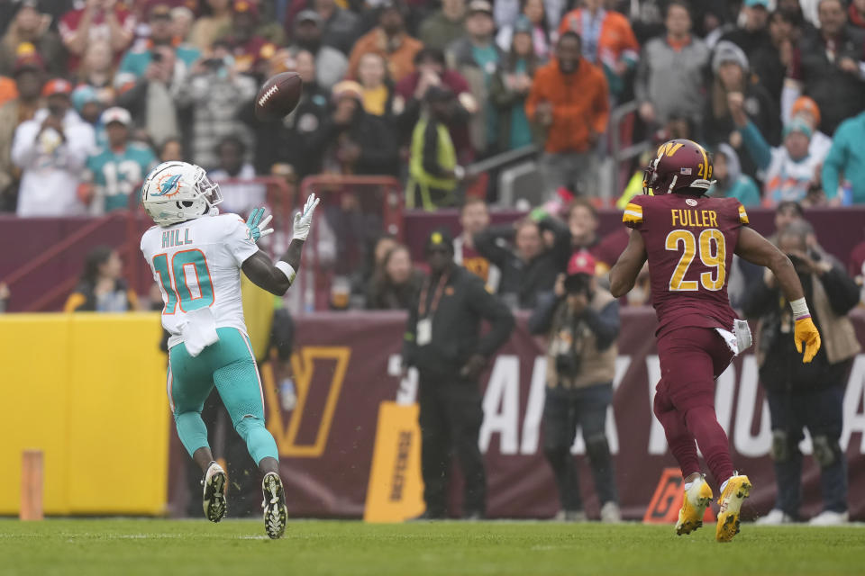 Miami Dolphins wide receiver Tyreek Hill (10) catches a touchdown pass in front of Washington Commanders cornerback Kendall Fuller (29) during the first half of an NFL football game Sunday, Dec. 3, 2023, in Landover, Md. (AP Photo/Alex Brandon)