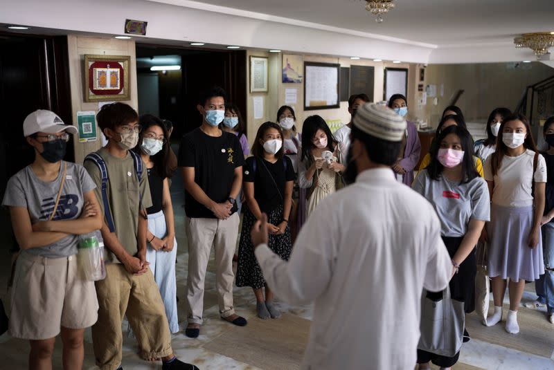 Tourists listen to introduction during a tour visiting refugee communities in Hong Kong