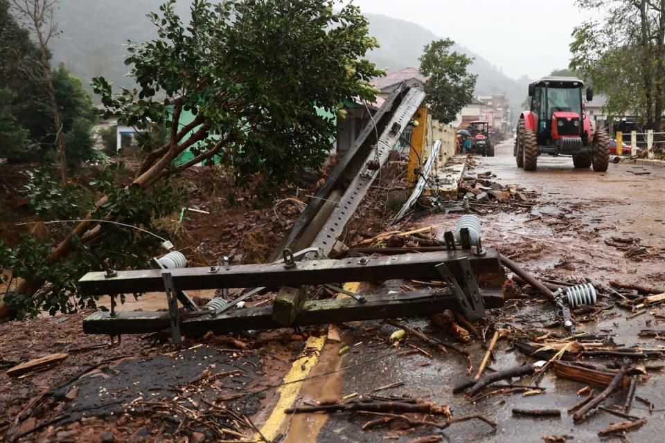 A tractor drives on a road affected by the floods at Encantado in Rio Grande do Sul (REUTERS)