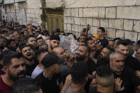 Palestinians carry the body of Islam Sabouh, who was killed during an operation by Israeli forces in the West Bank city of Nablus, Tuesday, Aug. 9, 2022. Israeli police said forces encircled the home of Ibrahim al-Nabulsi, who they say was wanted for a string of shootings in the West Bank earlier this year. They said al-Nabulsi and another Palestinian militant were killed in a shootout at the scene, and that troops found arms and explosives in his home. (AP Photo/Majdi Mohammed)