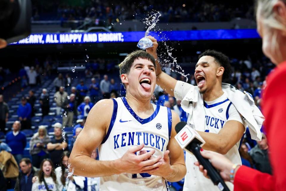 Kentucky freshman Reed Sheppard is sprayed with water by teammate Tre Mitchell after Tuesday’s ACC/SEC Challenge game against Miami at Rupp Arena.