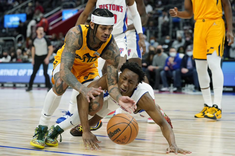 Utah Jazz guard Jordan Clarkson (00) and Detroit Pistons guard Saben Lee (38) chase the loose ball during the second half of an NBA basketball game, Monday, Jan. 10, 2022, in Detroit. (AP Photo/Carlos Osorio)