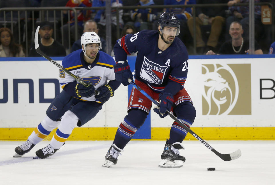 New York Rangers forward Chris Kreider (20) controls the puck while pursued by St. Louis Blues center Jordan Kyrou (25) during the first period of an NHL hockey game Saturday, March 9, 2024, in New York. (AP Photo/John Munson)