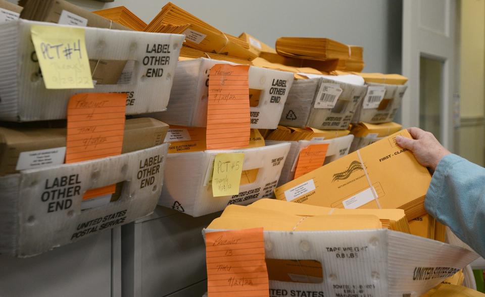 In Hyannis, Town Clerk Ann Quirk sorted through boxes of mail in voting envelopes as they await arrival of the ballots to stuff in each one at Barnstable Town Hall on Oct. 7.