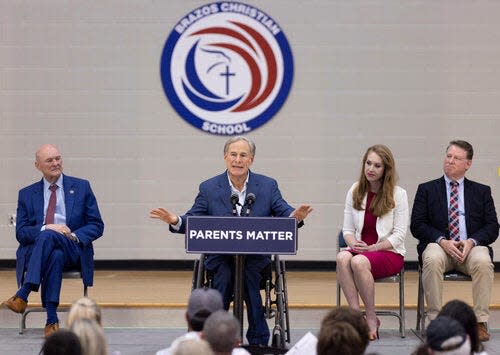Texas Gov. Greg Abbott, center, is seen speaking at Brazos Christian School in Bryan, Texas, on Tuesday, March 7, 2023. Abbott visited the school as apart of the Parent Empowerment Coalition's tour.