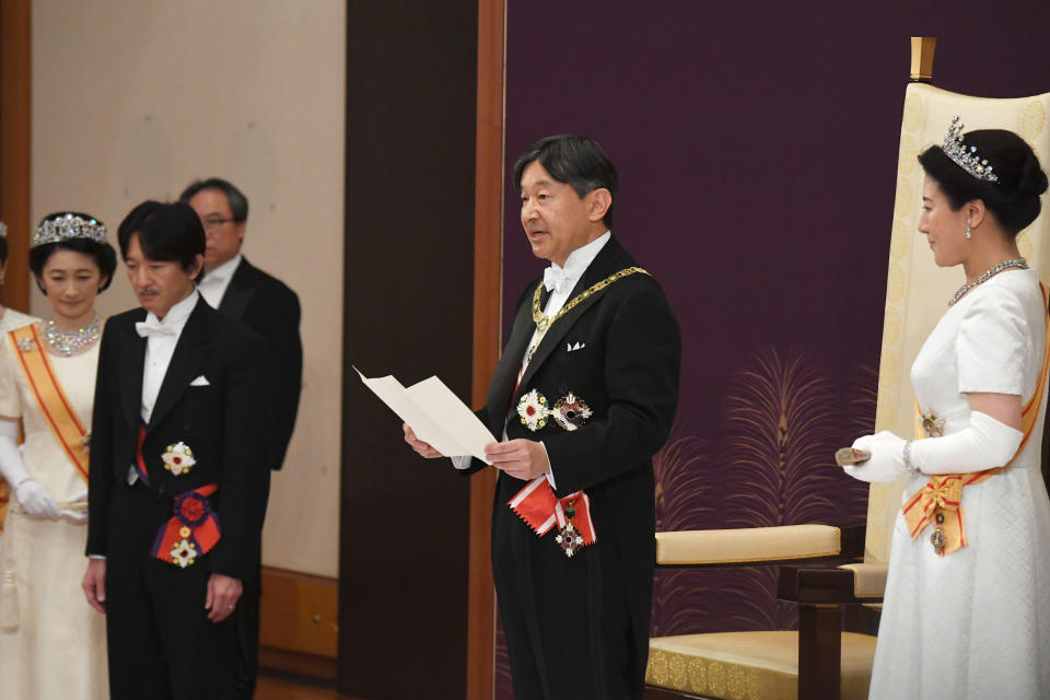 Japan's new Emperor Naruhito, accompanied by new Empress Masako, makes his first address during a ritual after succeeding his father Akihito at Imperial Palace in Tokyo, Wednesday, May 1, 2019. Crown Prince and Crown Princess Akishino are seen at left. (Japan Pool via AP)