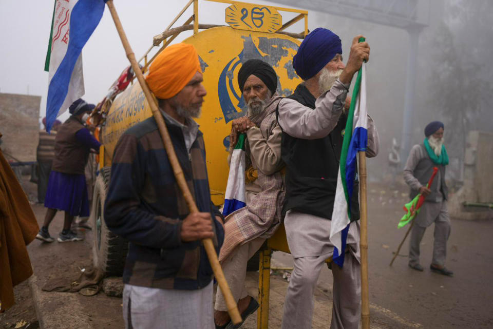 Indian farmers who have been protesting for a week to demand guaranteed crop prices wait to march to the capital near Shambhu border that divides northern Punjab and Haryana states, some 200 kilometers (120 miles) from New Delhi, India, Wednesday, Feb.21, 2024. The protesting farmers began their march last week, but their efforts to reach the city have been blocked by authorities. (AP Photo/Altaf Qadri)