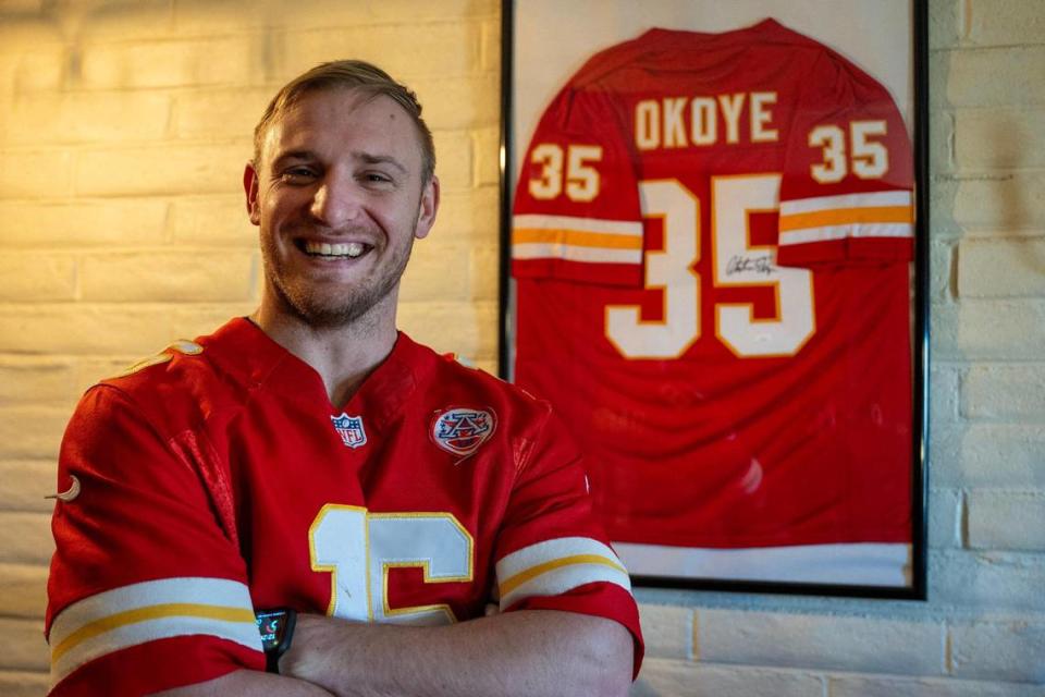 Philip Rineberg, a Kansas City Chiefs fan, displays a framed signed jersey from former Kansas City Chiefs running back Christian Okoye at his home on Monday, Feb. 5, 2024, in Guymon, Okla.