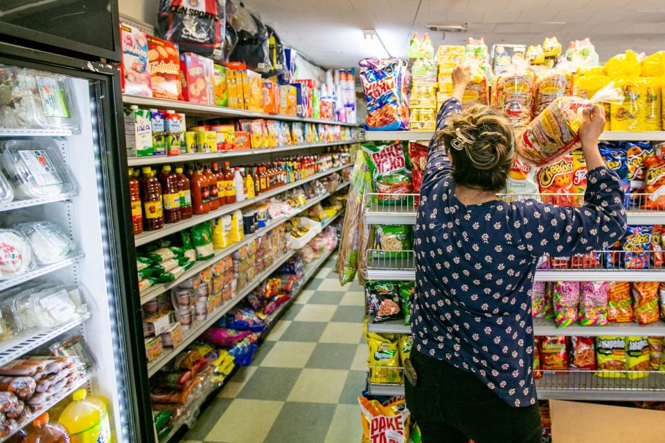 Antonia stocks the shelves at a convenience store in the Florida Panhandle on Thursday, June 8, 2023. 