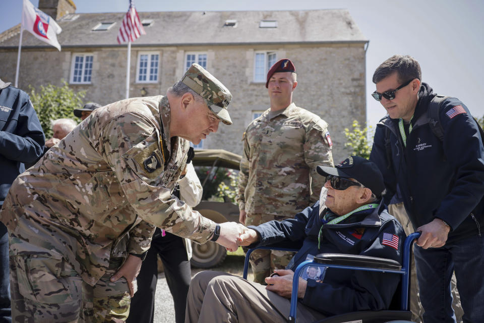 U.S. Gen. Mark Milley, left, shakes hands with Tec4 Moshe D. Lenske during a gathering in preparation of the 79th D-Day anniversary in La Fiere, Normandy, France, Sunday, June 4, 2023. The landings on the coast of Normandy 79 year ago by U.S. and British troops took place on June 6, 1944. (AP Photo/Thomas Padilla)