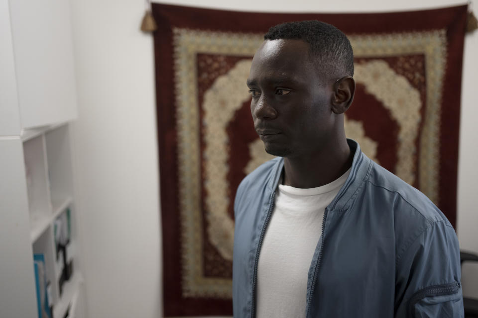 Omer Easa from Sudan poses for a portrait inside the offices of the Hotline for Migrant Workers, a rights group, in Tel Aviv, Israel, Sunday, April 30, 2023. "My heart is there. My head is there. It is just that my body is here," said Easa, 31, a political dissident who fled the war-torn region of Darfur in 2012. "We live here often thanks to the graces of the Supreme Court." (AP Photo/Maya Alleruzzo)