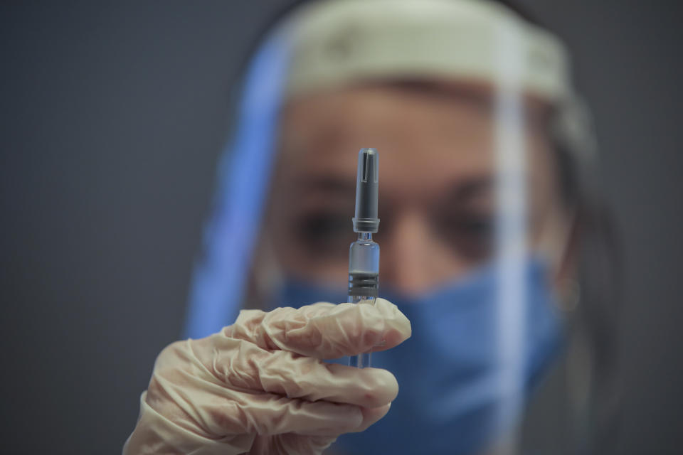 FILE - In this Monday, Dec. 21, 2020 file photo, nurse Arzu Yildirim poses for the photographer as she holds a CoronaVac vaccine, made by Sinovac, then on phase III clinical trials at Acibadem Hospital in Istanbul. Turkish authorities on Wednesday, Jan. 13, 2021, gave the go-ahead for the emergency use of the COVID-19 vaccine produced by China's Sinovac Biotch Ltd. paving the way for the rollout for Turkey's vaccination program starting with health care workers and other high-risk groups in the country of 83 million.Turkey has reported some 2.34 million infections and around 23,000 deaths. (AP Photo/Emrah Gurel, File)