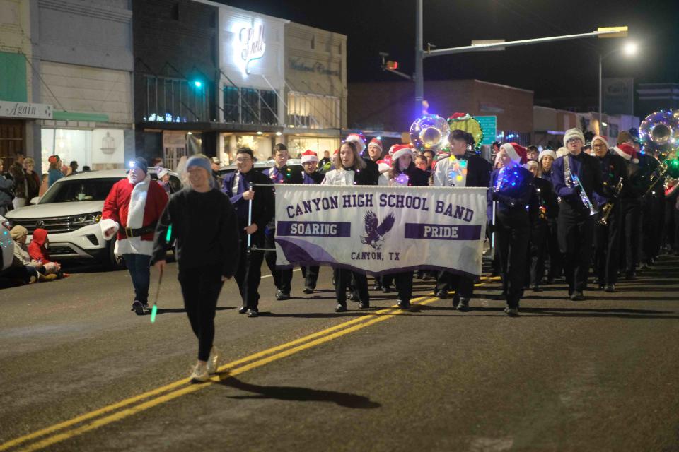 The Canyon High School Marching Band gets the crowd in the Christmas Spirit Saturday Night at the Parade of Lights Canyon, Texas.