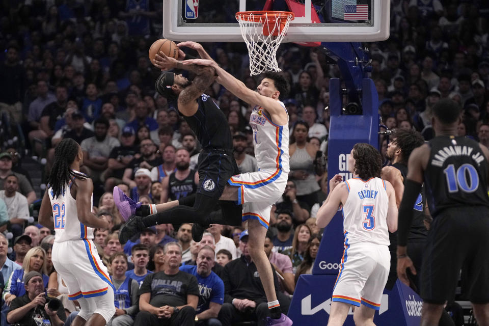 Dallas Mavericks' Jaden Hardy is fouled shooting by Oklahoma City Thunder's Chet Holmgren, center right, in the first half of Game 6 of an NBA basketball second-round playoff series Saturday, May 18, 2024, in Dallas. (AP Photo/Tony Gutierrez)