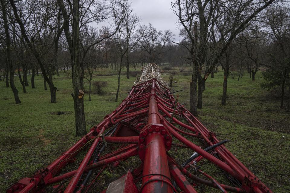 A TV tower lies in the park after beinf blown up by Russian forces in Kherson, Ukraine, Thursday, Dec. 8, 2022. (AP Photo/Evgeniy Maloletka)