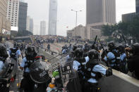 FILE - Riot police gather face off with demonstrators near the Legislative Council in Hong Kong on June 12, 2019. When the British handed its colony Hong Kong to Beijing in 1997, it was promised 50 years of self-government and freedoms of assembly, speech and press that are not allowed Chinese on the Communist-ruled mainland. As the city of 7.4 million people marks 25 years under Beijing's rule on Friday, those promises are wearing thin. Hong Kong's honeymoon period, when it carried on much as it always had, has passed, and its future remains uncertain, determined by forces beyond its control. (AP Photo/Kin Cheung, File)