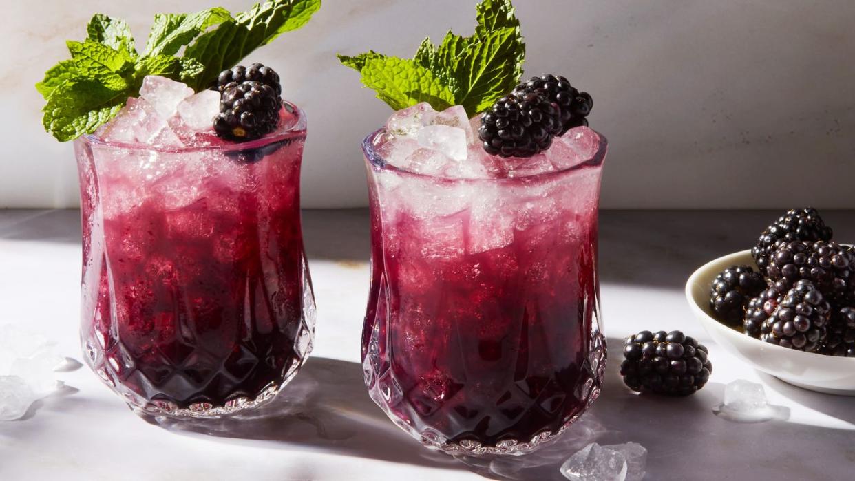 purple blackberry mint julep with crushed ice garnished with a blackberry and mint sprig