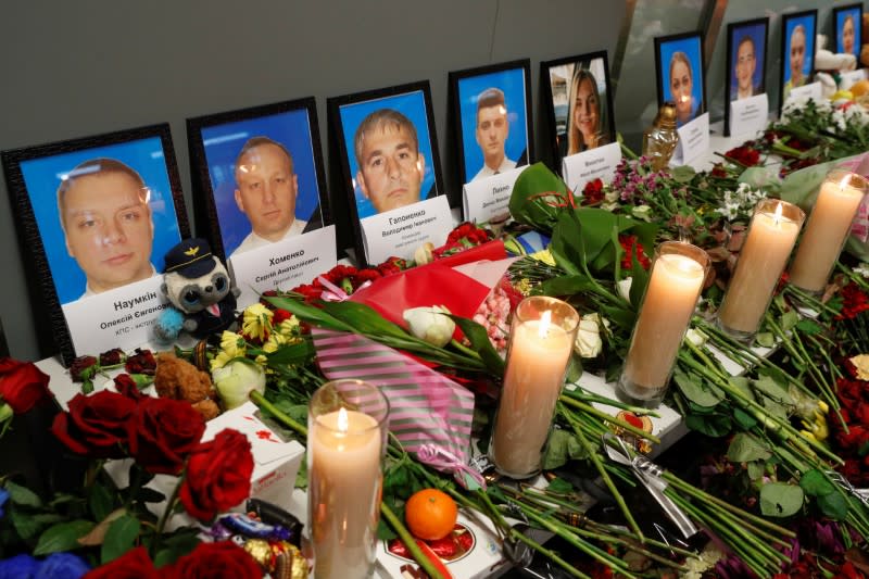 Flowers and candles are placed in front of the portraits of the flight crew members of the Ukraine International Airlines Boeing 737-800 plane that crashed in Iran, at a memorial at Boryspil International airport