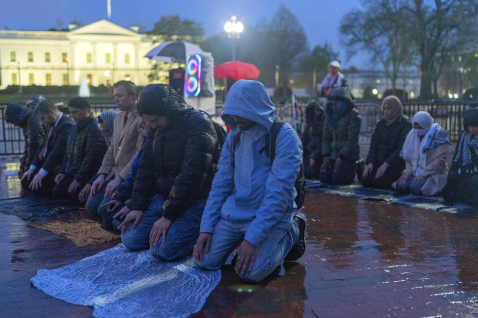 Protesters pray during a demonstration in support of Palestinians, Tuesday, April 2, 2024, at Lafayette Park across from the White House in Washington,. (AP Photo/Jose Luis Magana)