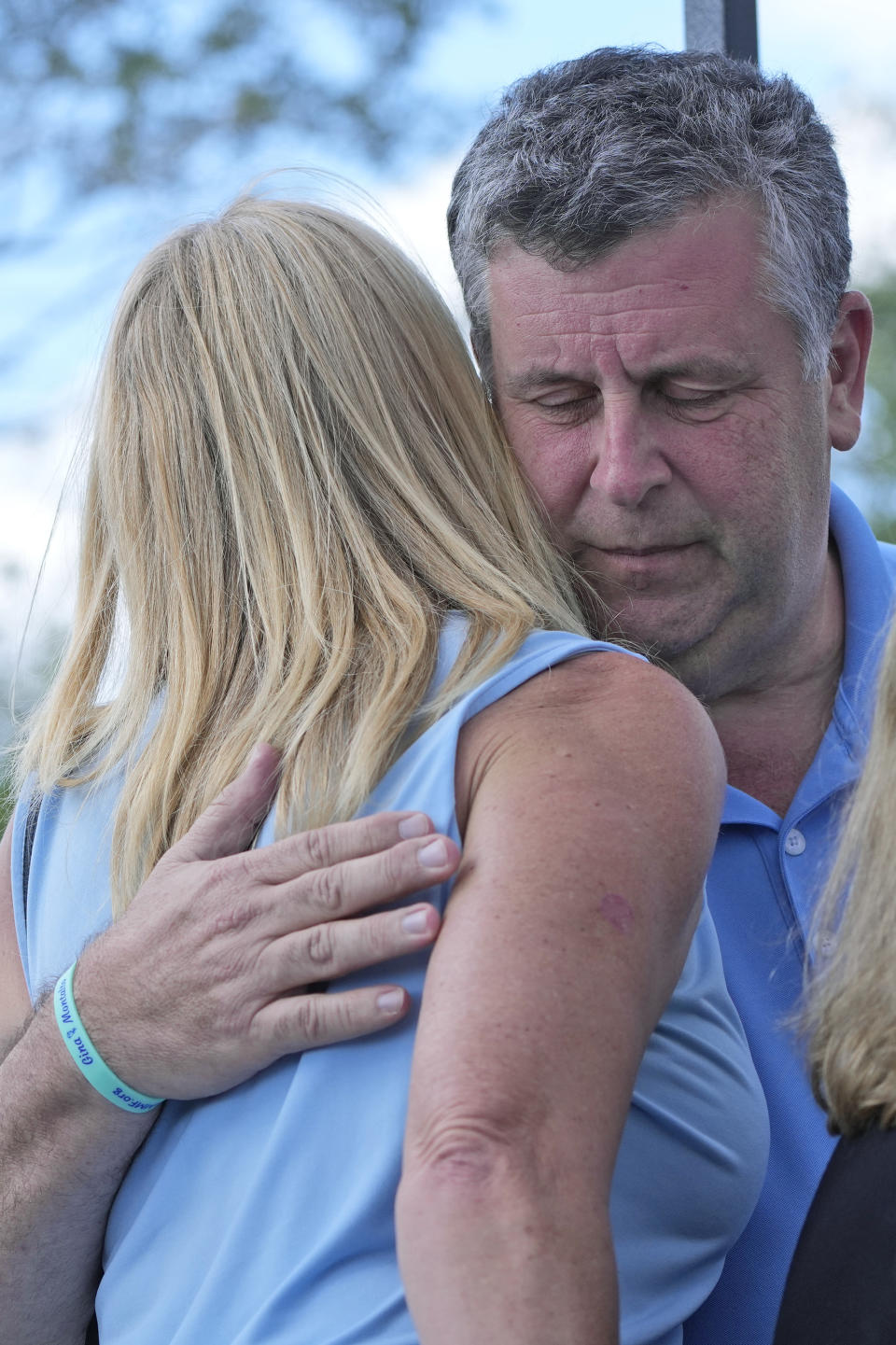 Annika Dworet, left, mother of shooting victim Nicholas Dworet and Tony Montalto, right, father of shooting victim Gina Montalto, hug, Tuesday, Feb. 14, 2023, at a ceremony in Coral Springs, Fla., honoring the lives of the 17 students and staff of Marjory Stoneman Douglas High School that were killed on Valentine's Day, 2018. (AP Photo/Wilfredo Lee)