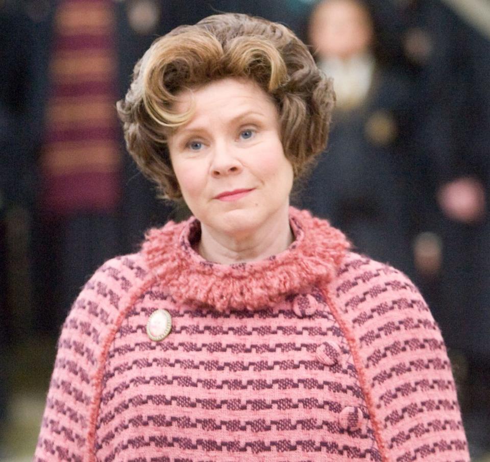 Delores Umbridge in all pink looking smug