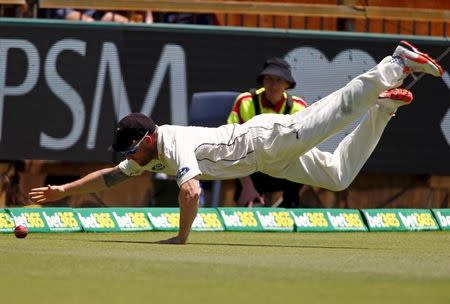 New Zealand's captain Brendon McCullum dives to stop a boundary during the second day of the second cricket test match against Australia at the WACA ground in Perth, Western Australia, November 14, 2015. REUTERS/David Gray