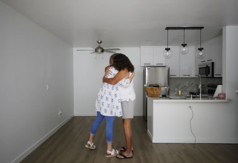 SAN DIEGO, CA - SEPTEMBER 19: Hope Shaw, a housing specialist for PATH (People Assisting The Homeless) hugs Bruce Blackham in his new apartment she arranged for on Monday, September 19, 2022 in San Diego, CA. An Emergency Housing Voucher funded by the American Rescue Plan Act was used to secure an apartment for him. (K.C. Alfred / The San Diego Union-Tribune)