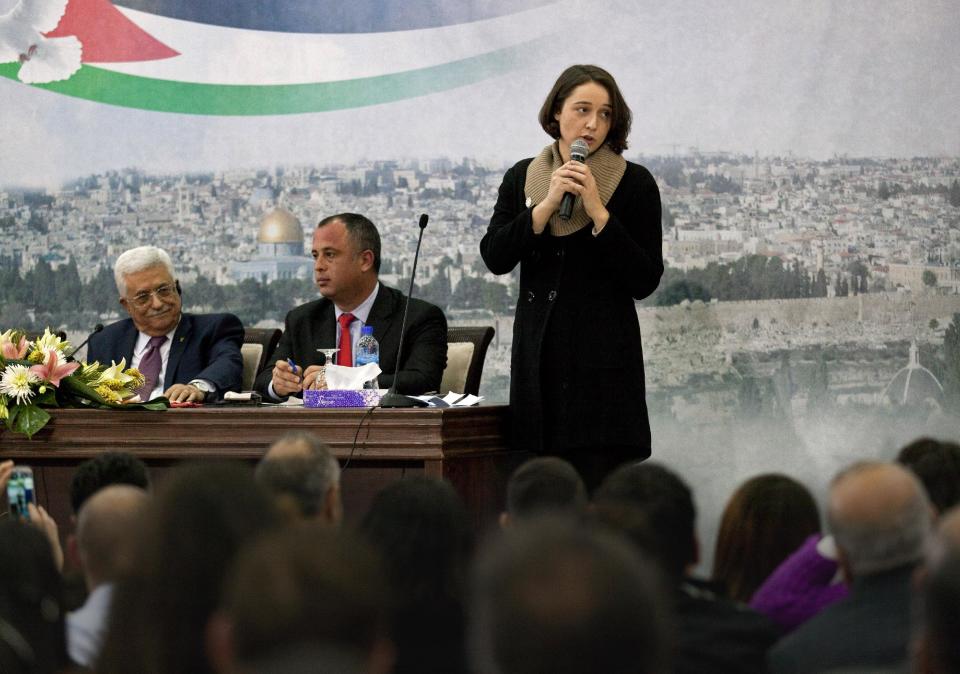 OneVoice Israel executive director Laura Talinovsky, right, talks next to Palestinian President Mahmoud Abbas, left and Israeli Labor Knesset Member Hilik Bar, center during a meeting with a delegation of Israeli university students and activists at the presidential headquarters in the West Bank city of Ramallah, Sunday, Feb. 16, 2014. Abbas said that he does not want to "drown Israel with millions of (Palestinian) refugees to change its nature." Abbas' comment Sunday was his most conciliatory yet on the fate of Palestinian refugees who were uprooted from homes in what is now Israel, including in the 1948 war over Israel's creation. (AP Photo/Nasser Nasser)