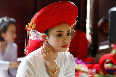 Medium Pham Ha Thanh prepares for her performance at a Hau Dong ceremony at Chau De Tu temple in Thanh Hoa province in Vietnam, May 15, 2017. REUTERS/Kham