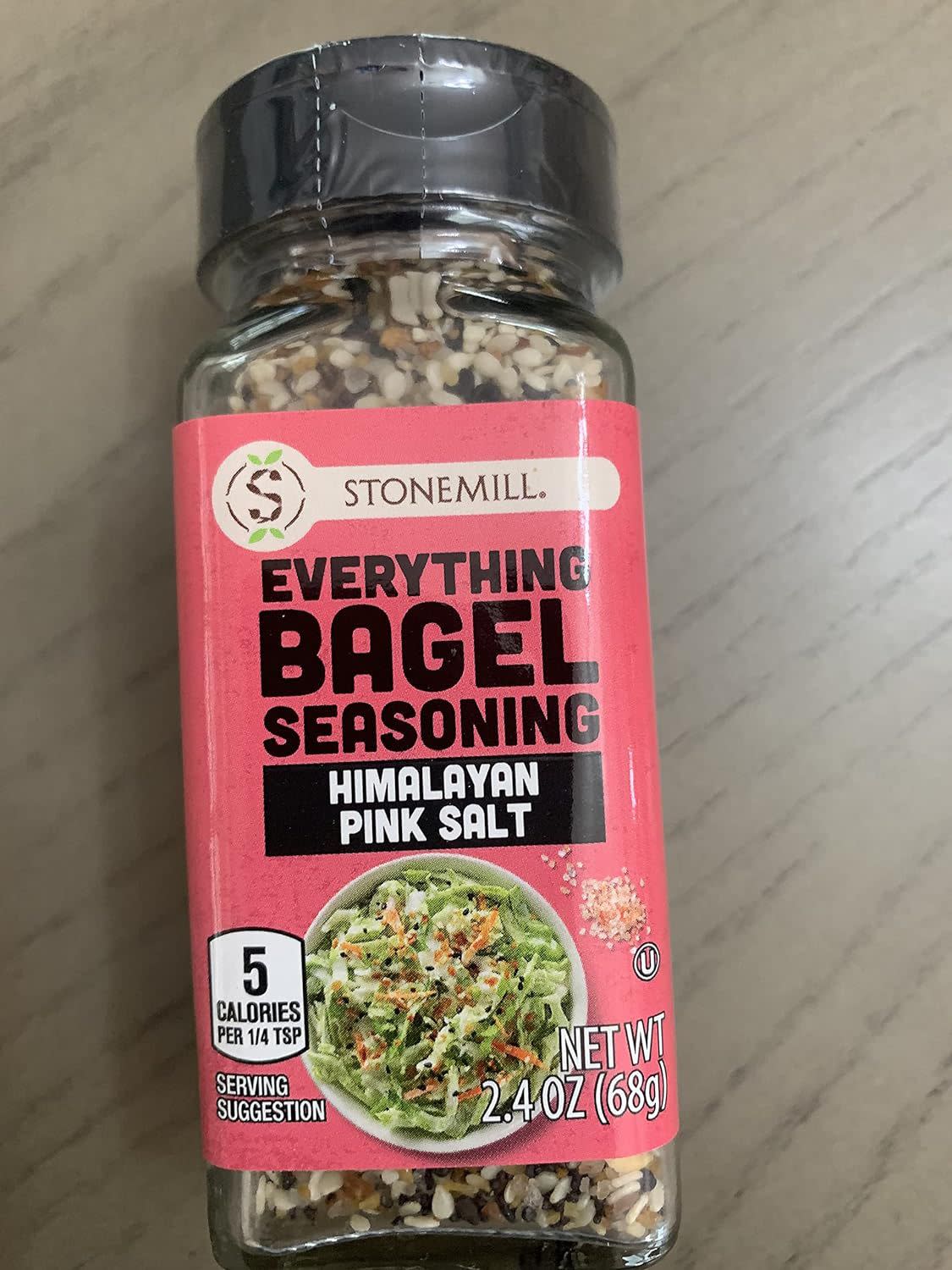 Stonemill Everything Bagel Seasoning Himalayan Pink Salt, laid down on a wooden table