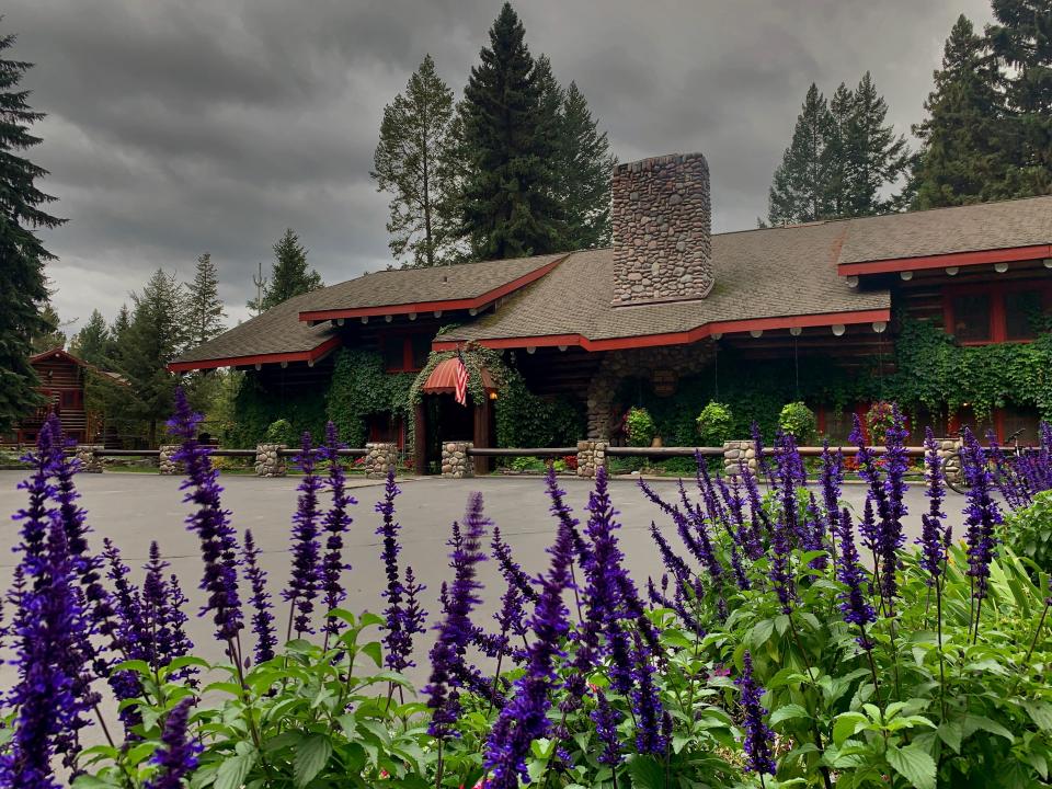 A lodge building with purple flowers in front.