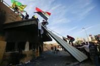 Supporters and members of the Hashed al-Shaabi paramilitary force gather during a demonstration outside the US embassy in the Iraqi capital Baghdad