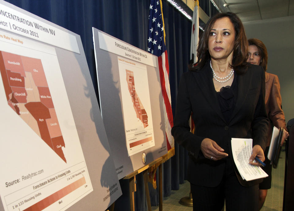 Attorneys General Kamala D. Harris of California, left, and Catherine Cortez Masto of Nevada walk past foreclosure charts of their states after they announce a joint investigation alliance to assist homeowners who have been harmed by misconduct and fraud in the mortgage industry, during a news conference in Los Angeles Tuesday, Dec. 6, 2011. (AP Photo/Damian Dovarganes)