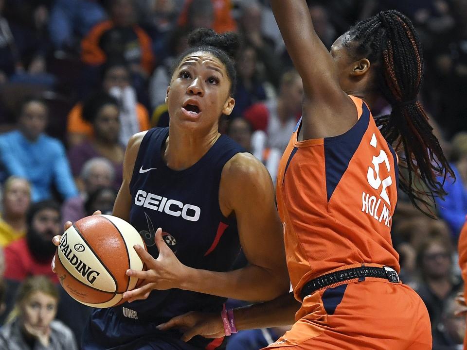 Washington Mystics' Aerial Powers, left, drives to the basket as Connecticut Sun's Bria Holmes defends during the second half in Game 4 of basketball's WNBA Finals, Tuesday, Oct. 8, 2019, in Uncasville, Conn. (AP Photo/Jessica Hill)