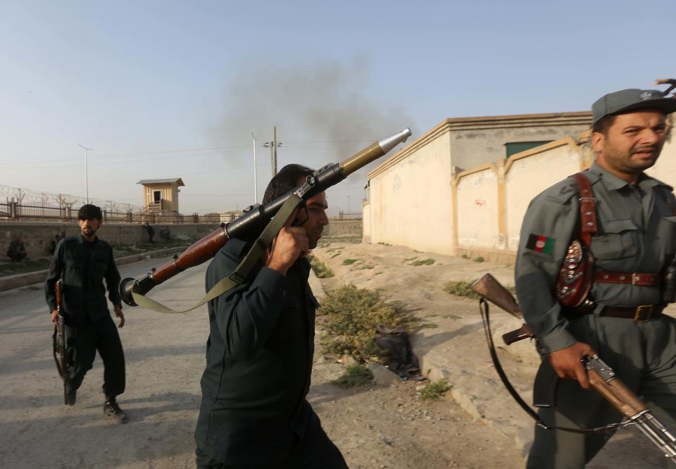 Afghan policemen arrive at the site of an attack in Kabul July 17, 2014. Explosions and bursts of gunfire were heard near Kabul International Airport in the Afghan capital after dawn on Thursday and black smoke rose above the facility, which is used by civilians and the military. (REUTERS/Omar Sobhani)