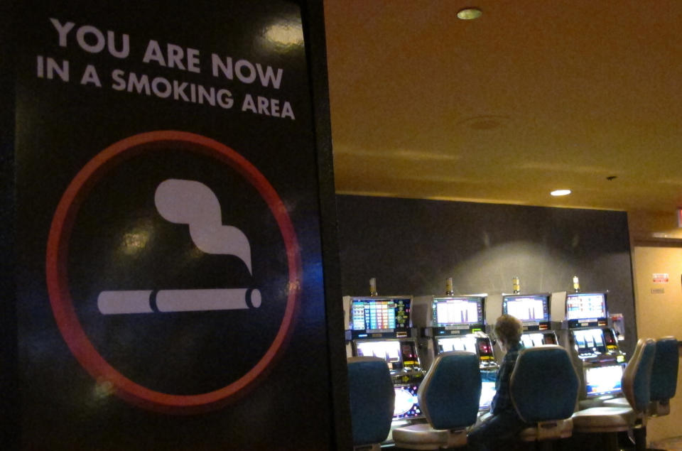 This March 9, 2016 photo shows a sign denoting a smoking section of the casino floor at the Tropicana casino in Atlantic City, N.J. On Thursday, April 15, 2021, health advocates, smoking opponents and some New Jersey lawmakers called for the state's temporary ban on casino smoking, imposed last year due to the coronavirus pandemic, be made permanent once the outbreak ends. (AP Photo/Wayne Parry)