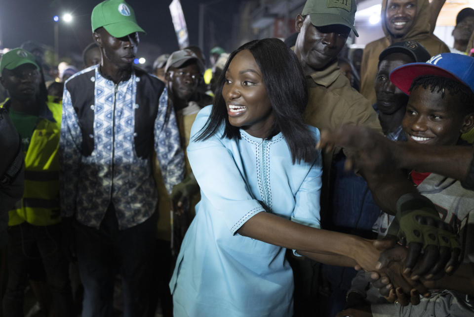 Presidential candidate Anta Babacar Ngom greets supporters during her electoral campaign caravan in Dakar, Senegal, Monday, March 11, 2024. Senegal’s only female presidential candidate may stand no chance of winning but activists say her presence alone is helping to advance a decades long campaign to achieve equality in the West African nation. (AP Photo/Sylvain Cherkaoui)