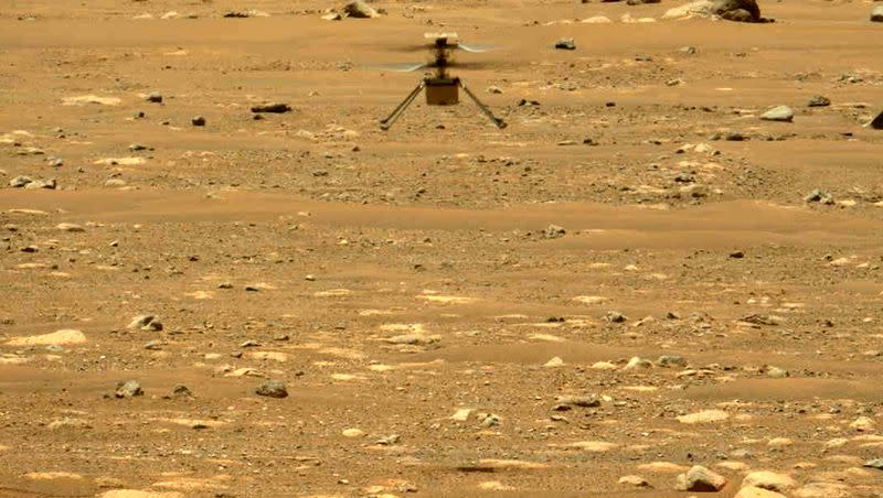 In this image made available by NASA, the Mars Ingenuity helicopter hovers above the surface of the planet during its second flight on April 22, 2021. On Thursday, Jan. 25, 2024, NASA announced that the 4-pound chopper can no longer fly because of rotor blade damage, and its mission is officially over.