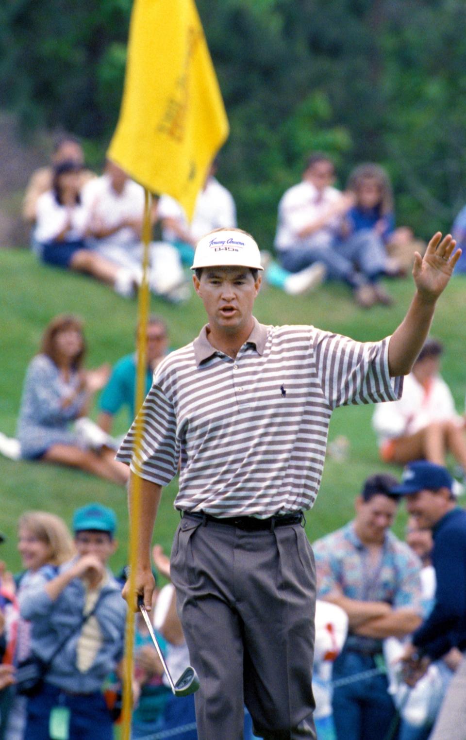 Davis Love III waves to fans as he walks to the pin after chipping his ball from the gallery behind the eighth green into the hole for birdie and the lead during the final round of the 1992 Players Championship. He went on to win by four shots. [Bob Self/Florida Times-Union]