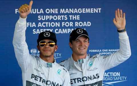 Mercedes Formula One driver Hamilton of Britain and his team mate Rosberg of Germany, celebrate after the qualifying session of the Russian F1 Grand Prix in the Sochi Autodrom circuit... - Credit: REUTERS