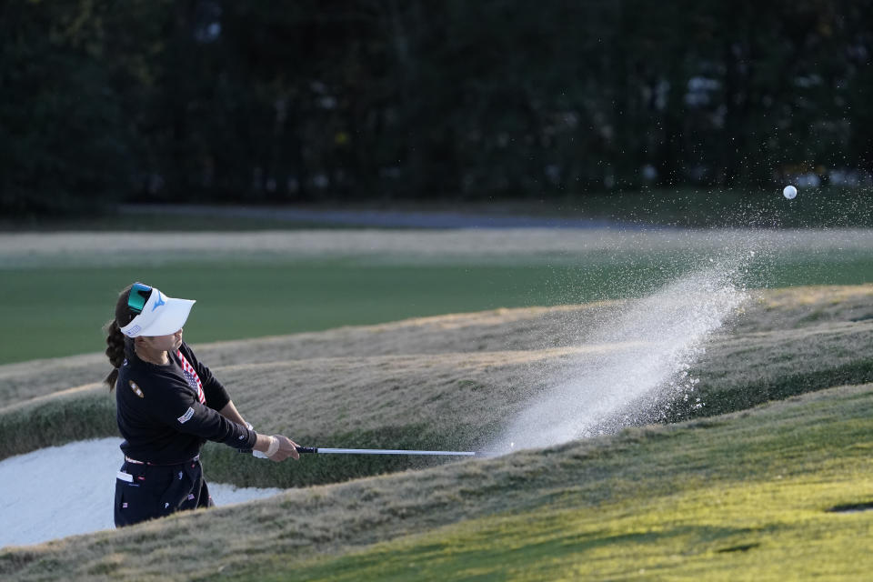 Saki Asai, of Japan, hits out of the bunker on the ninth hole, during the first round of the U.S. Women's Open Golf tournament, Thursday, Dec. 10, 2020, in Houston. (AP Photo/David J. Phillip)