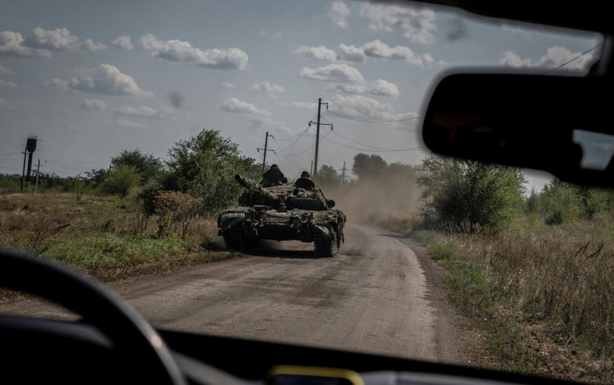 Ukrainian soldiers ride a tank near the village of Robotyne in Ukraine as the counteroffensive against Russia gains momentum