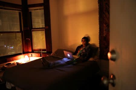 Vish Arya, 26, who is an operations analyst watches clips of Saturday Night Live on his computer in his bedroom at the Negev tech house in San Francisco, California, U.S. January 29, 2017. REUTERS/Gabrielle Lurie